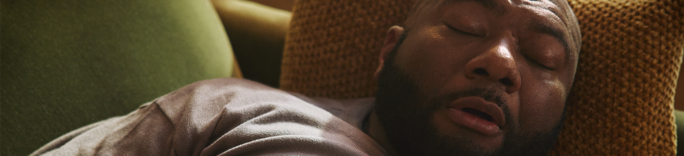 Man on couch sleeping.