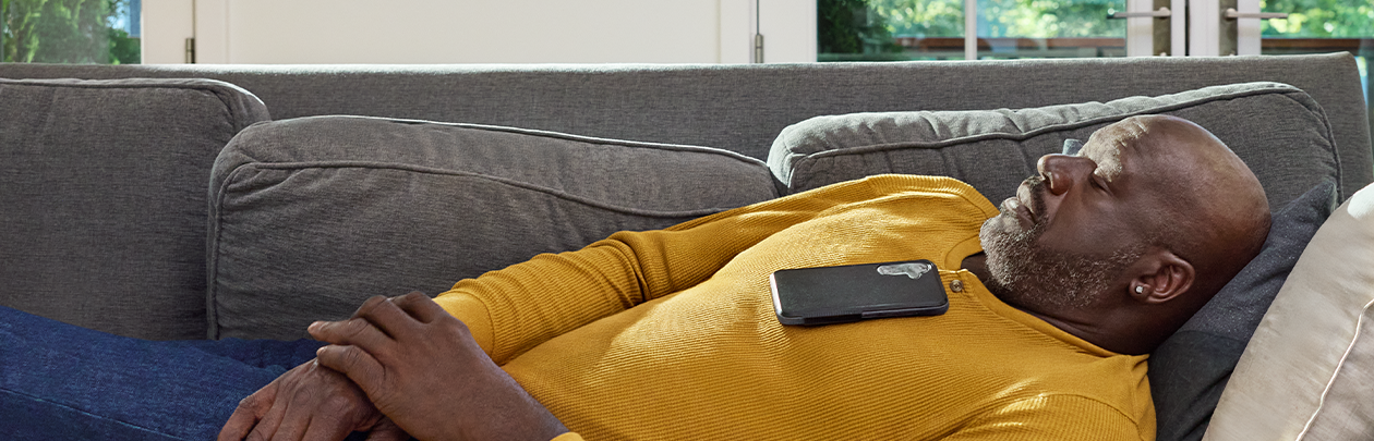 Shaquille O'Neal sleeping on a couch